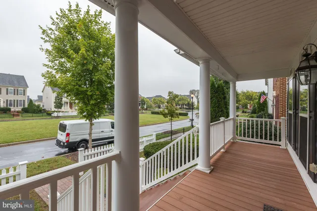 a view of a porch with wooden floor and fence