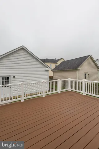 a view of a street with wooden fence