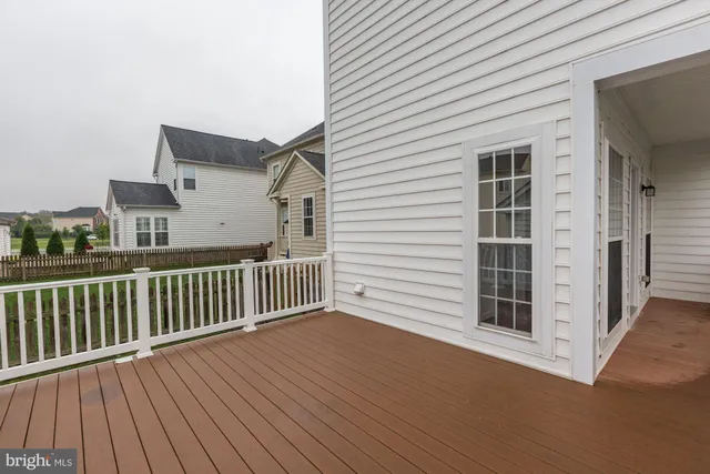 a view of house with a big yard and large tree