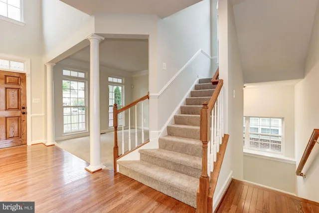 a view of staircase with white walls and windows