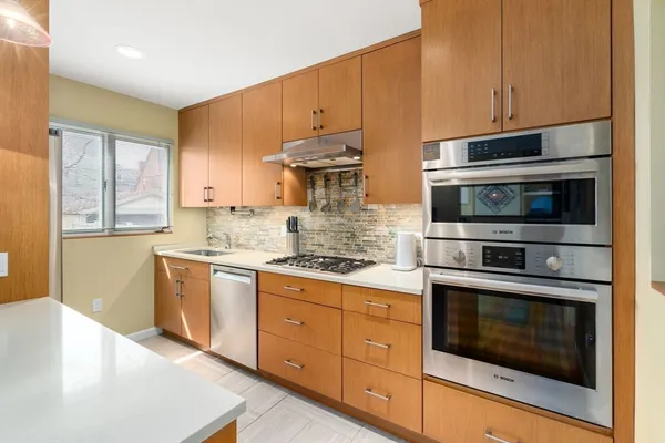 a kitchen that has a sink and a stove