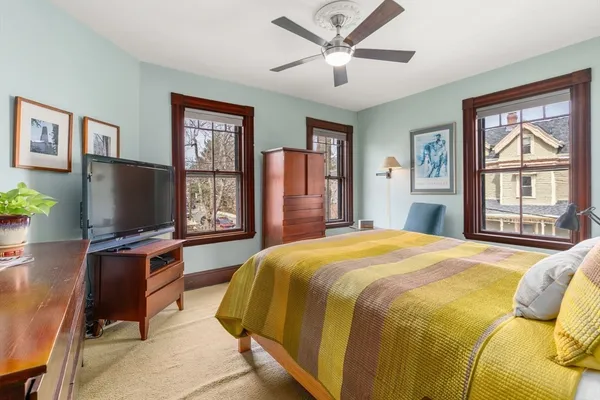 a spacious bedroom with a bed and a chandelier