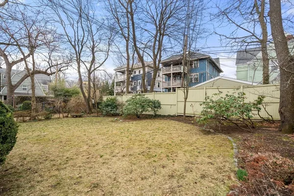 a view of a house with a yard covered in snow