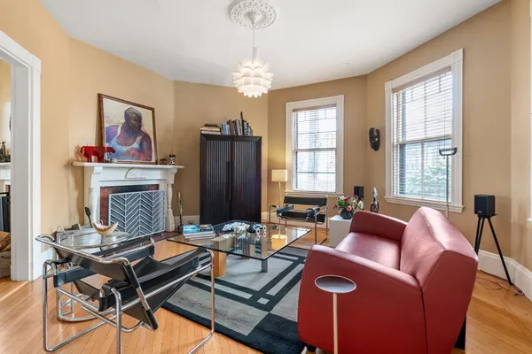 a living room with furniture a wooden floor and a window