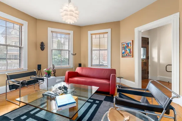 a view of a livingroom with furniture window and wooden floor