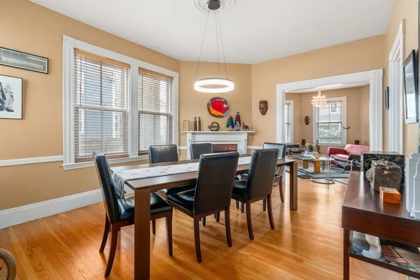 a dining room with furniture and wooden floor