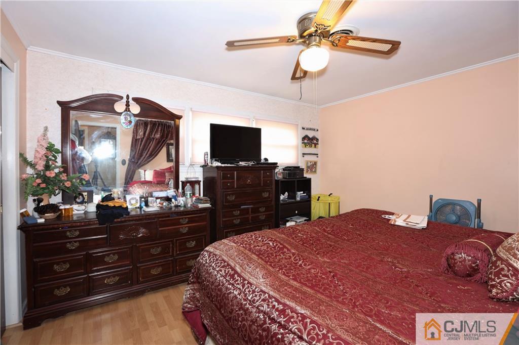 120 South Hill Road Colonia, NJ 07067 - Photo 12 of 26 a bedroom with a bed and a flat tv screen on dresser