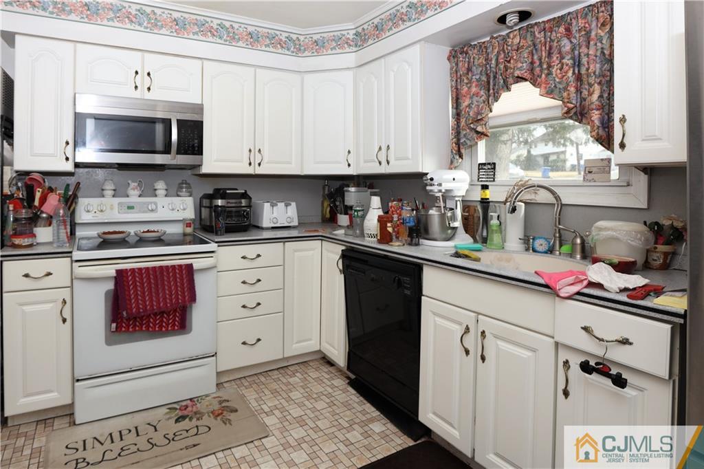 120 South Hill Road Colonia, NJ 07067 - Photo 14 of 26 a kitchen with stainless steel appliances granite countertop a sink a stove and a microwave