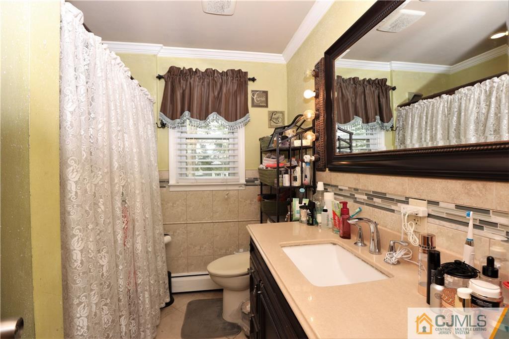 120 South Hill Road Colonia, NJ 07067 - Photo 15 of 26 a bathroom with a sink toilet and shower