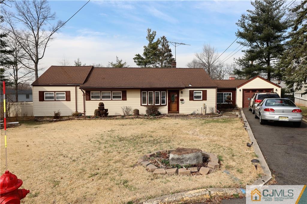 120 South Hill Road Colonia, NJ 07067 - Photo 3 of 26 a front view of a house with a yard and garage