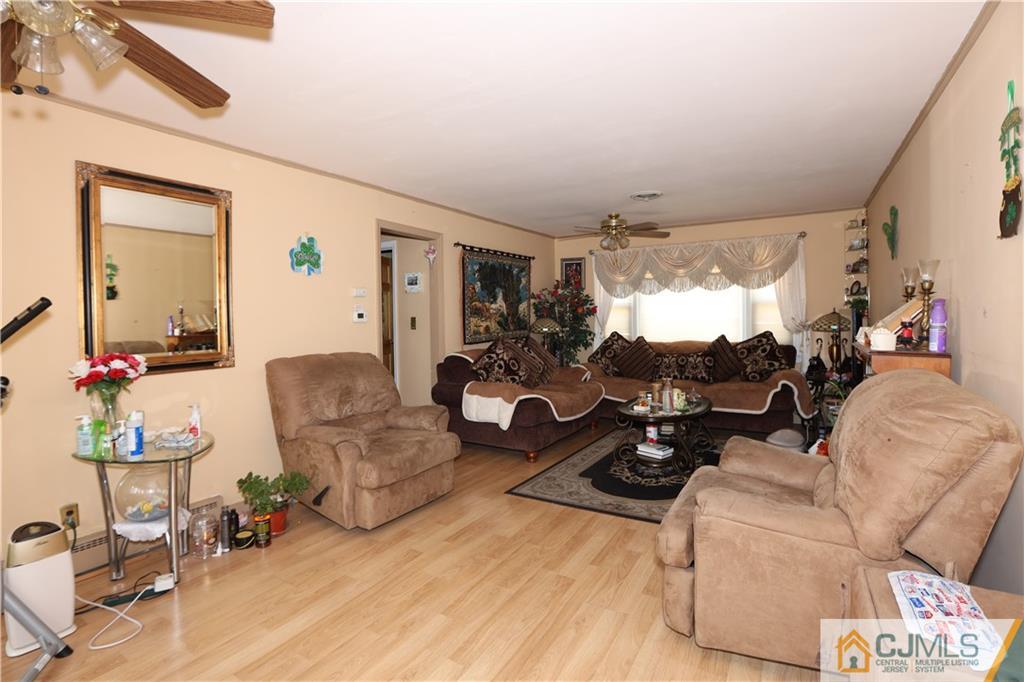 120 South Hill Road Colonia, NJ 07067 - Photo 4 of 26 a living room with furniture and a large window