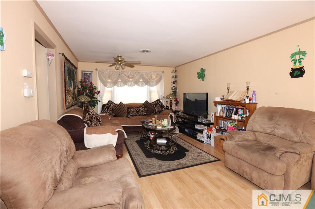 120 South Hill Road Colonia, NJ 07067 - Photo 5 of 26 a living room with furniture and a flat screen tv