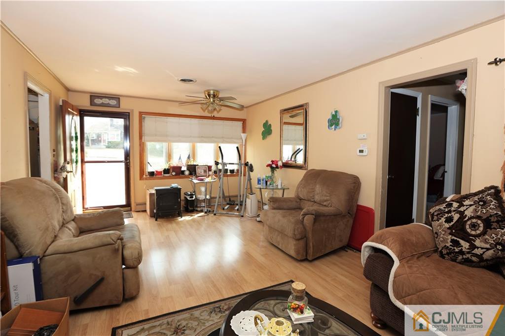 120 South Hill Road Colonia, NJ 07067 - Photo 6 of 26 a living room with furniture or couch and a large window