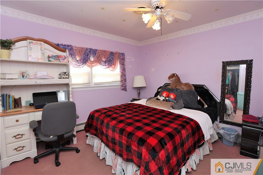 120 South Hill Road Colonia, NJ 07067 - Photo 7 of 26 a bedroom with a bed and a chandelier