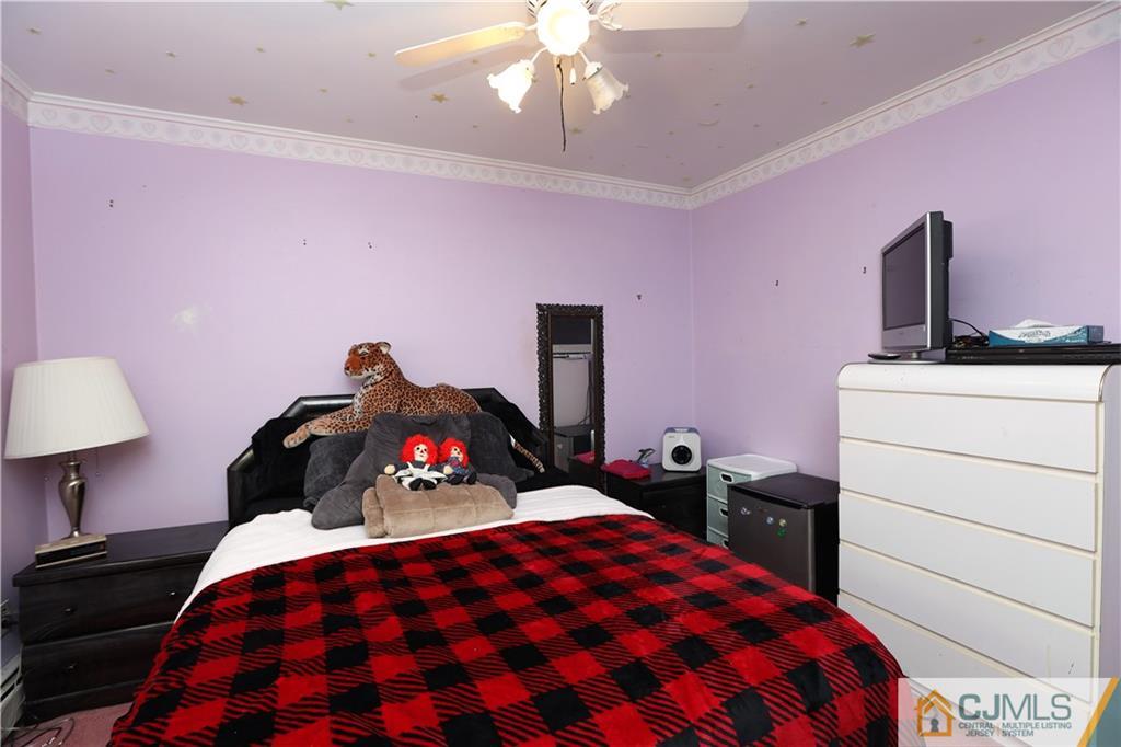 120 South Hill Road Colonia, NJ 07067 - Photo 8 of 26 a bedroom with a bed and a lamp on dresser