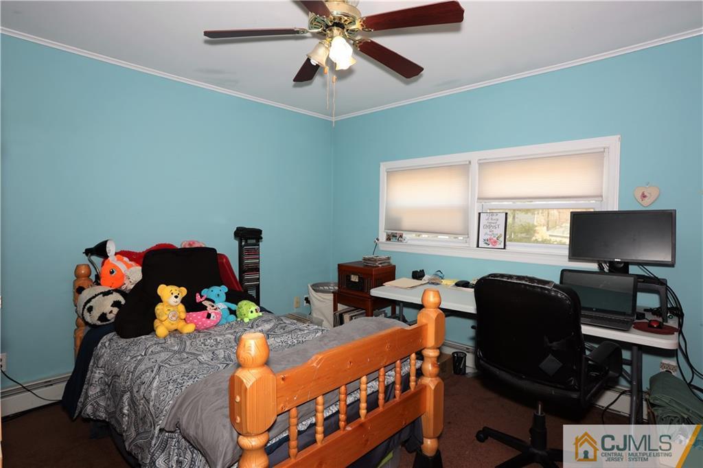120 South Hill Road Colonia, NJ 07067 - Photo 9 of 26 a bedroom with a bed and a chandelier