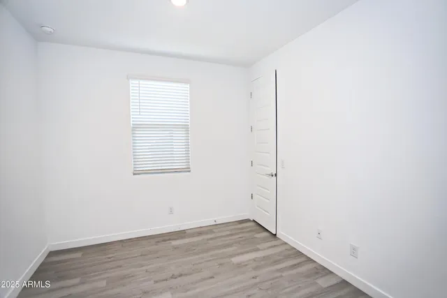 an empty room with wooden floor