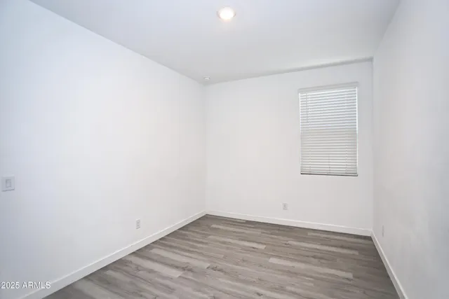 a view of an empty room and wooden floor