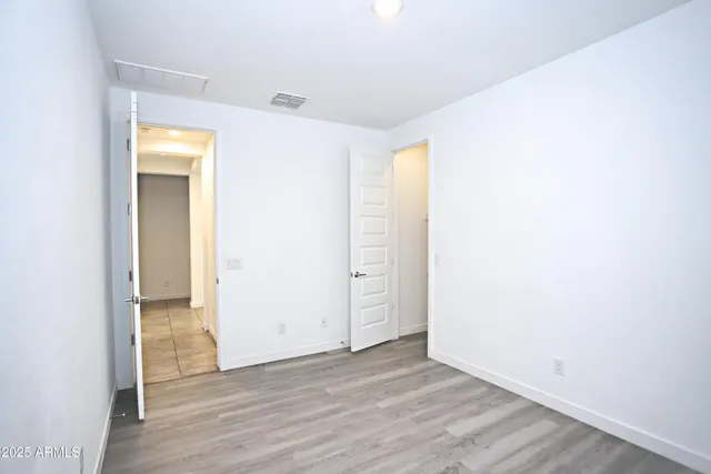 a bathroom with a granite countertop bathtub shower sink vanity and toilet