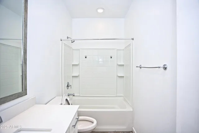 a bathroom with a sink a toilet and vanity