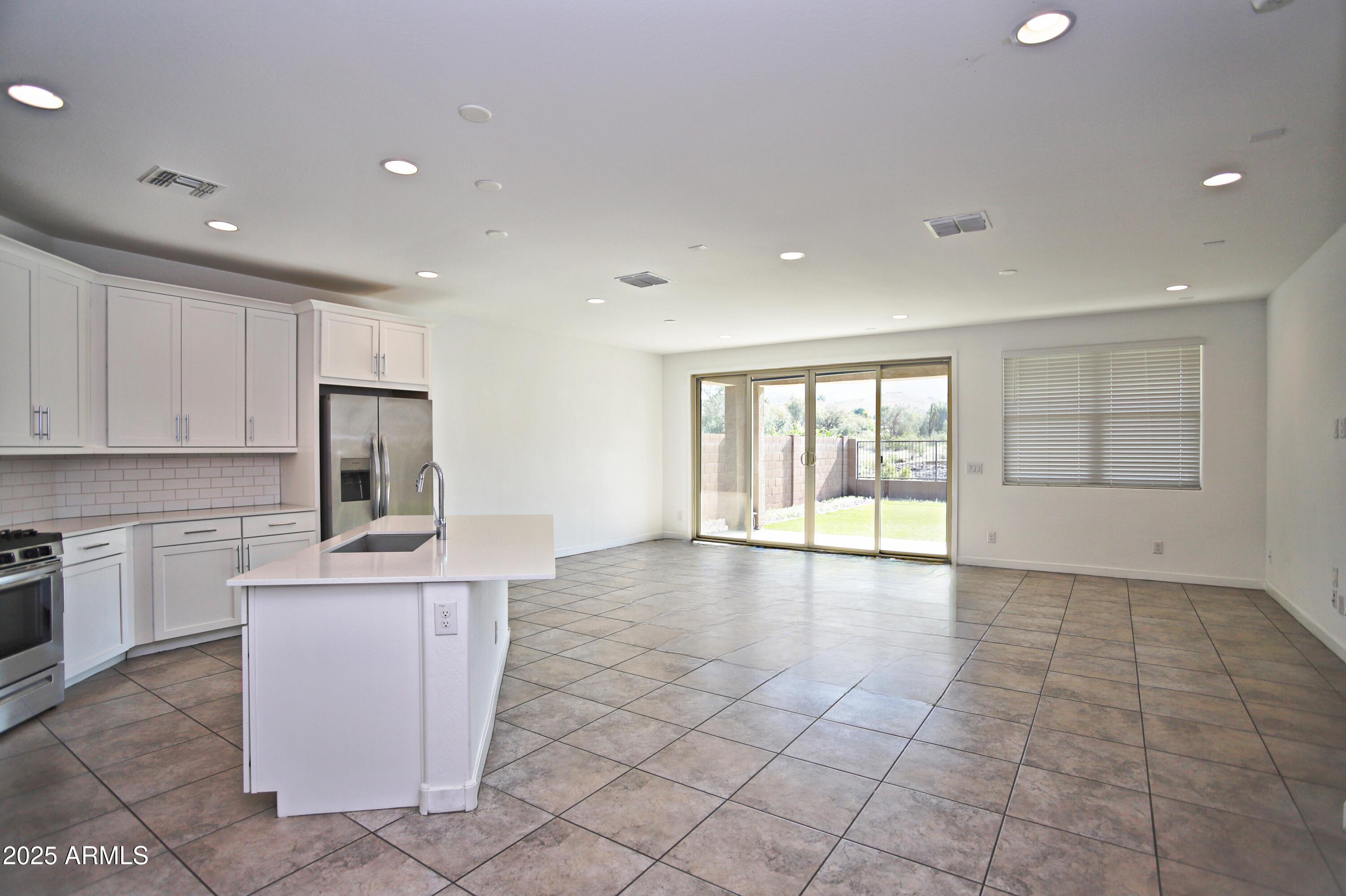 1535 West Corral Road Phoenix, AZ 85041 - Photo 18 of 39 a view of a kitchen with a sink cabinets and outdoor space