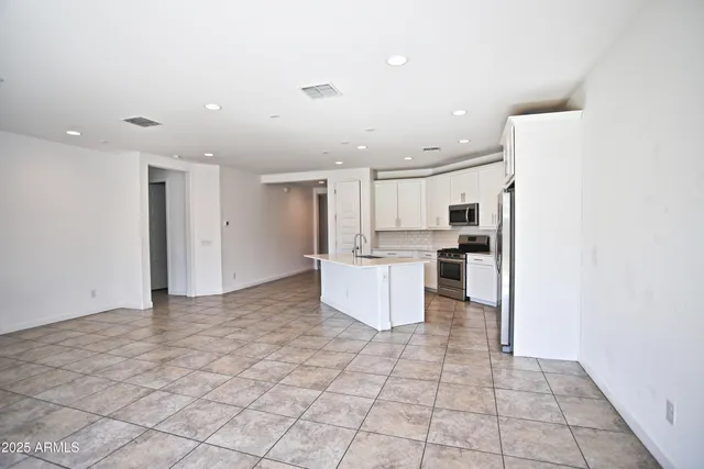a kitchen with cabinets and stainless steel appliances