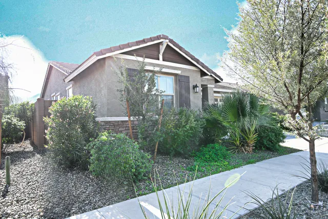 a front view of a house with garden