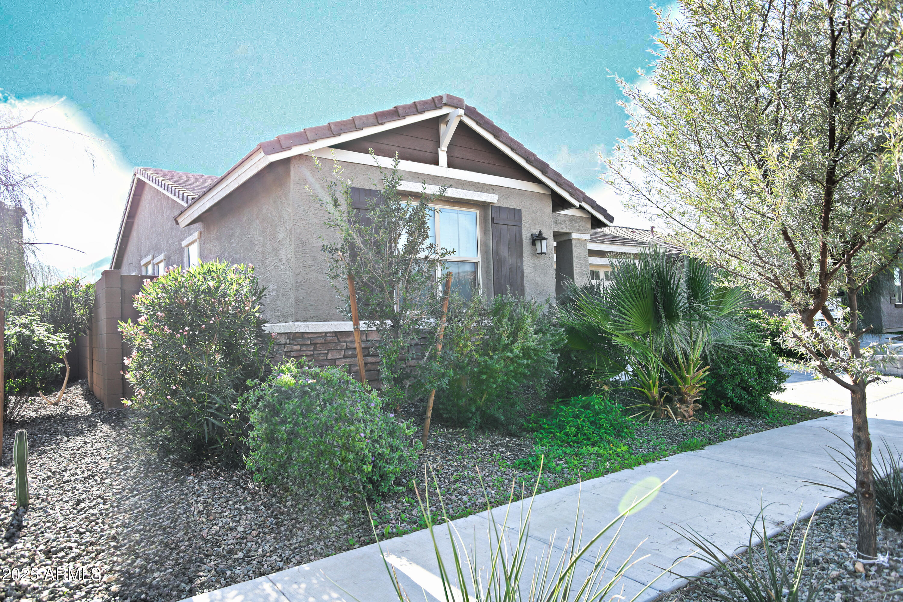 1535 West Corral Road Phoenix, AZ 85041 - Photo 2 of 39 a front view of a house with garden