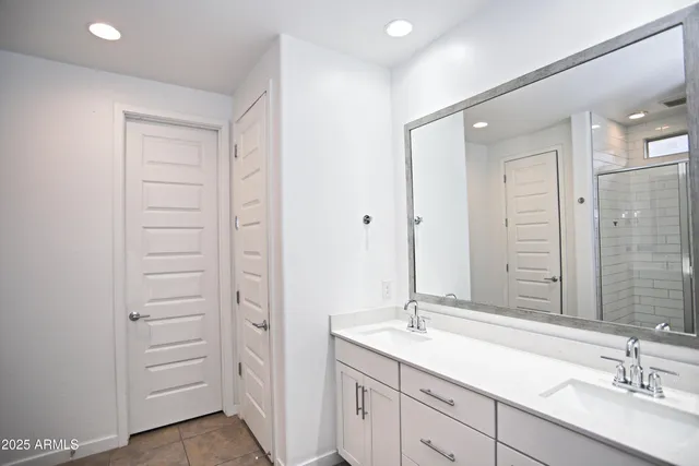 a bathroom with a shower sink and mirror