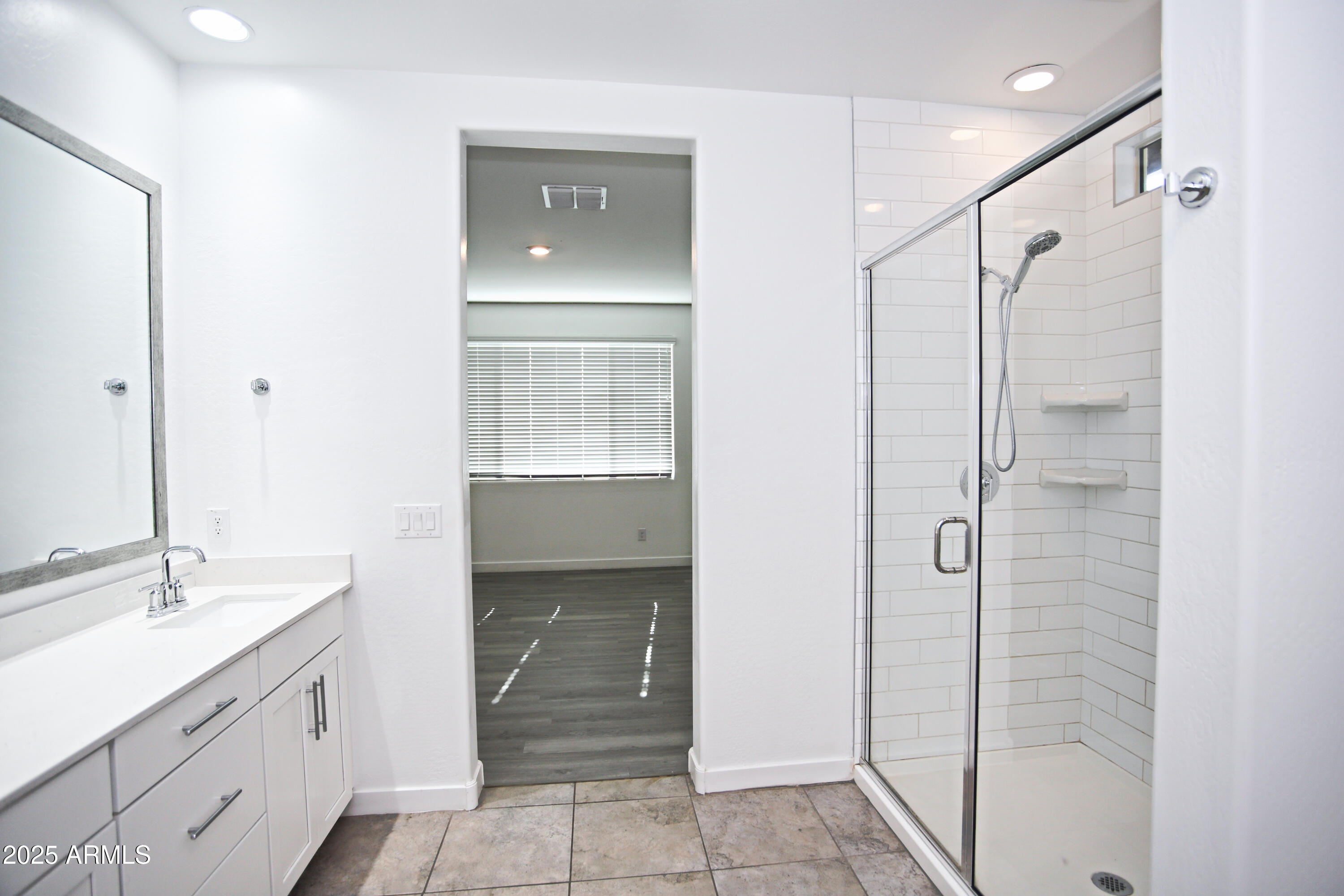 1535 West Corral Road Phoenix, AZ 85041 - Photo 26 of 39 a bathroom with a shower sink and mirror