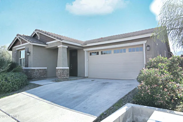 a view of house with garage and small yard