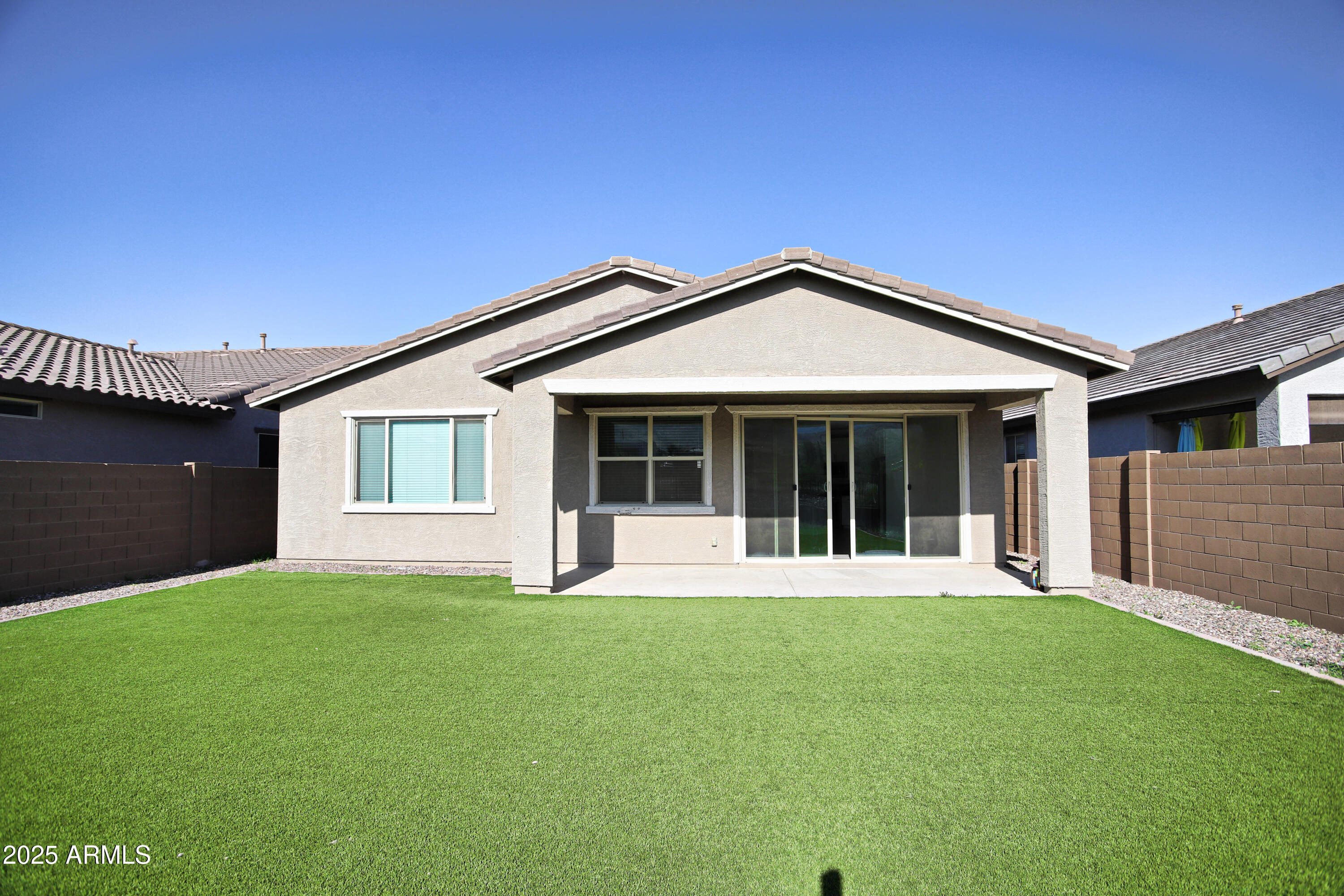 1535 West Corral Road Phoenix, AZ 85041 - Photo 32 of 39 a front view of a house with a yard and garage