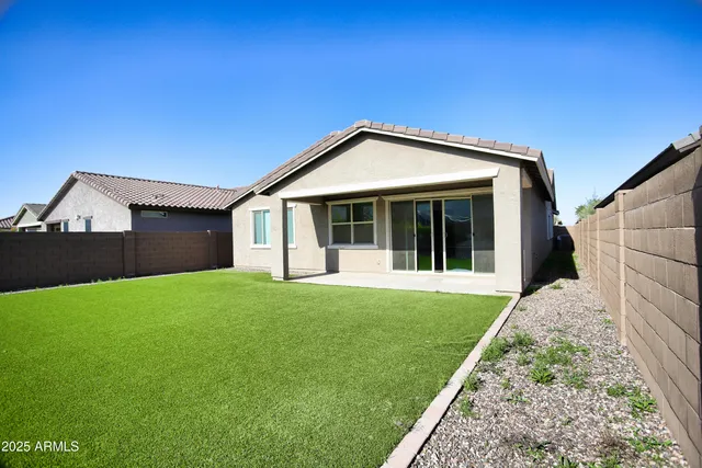 a view of a road with a bench in front of house
