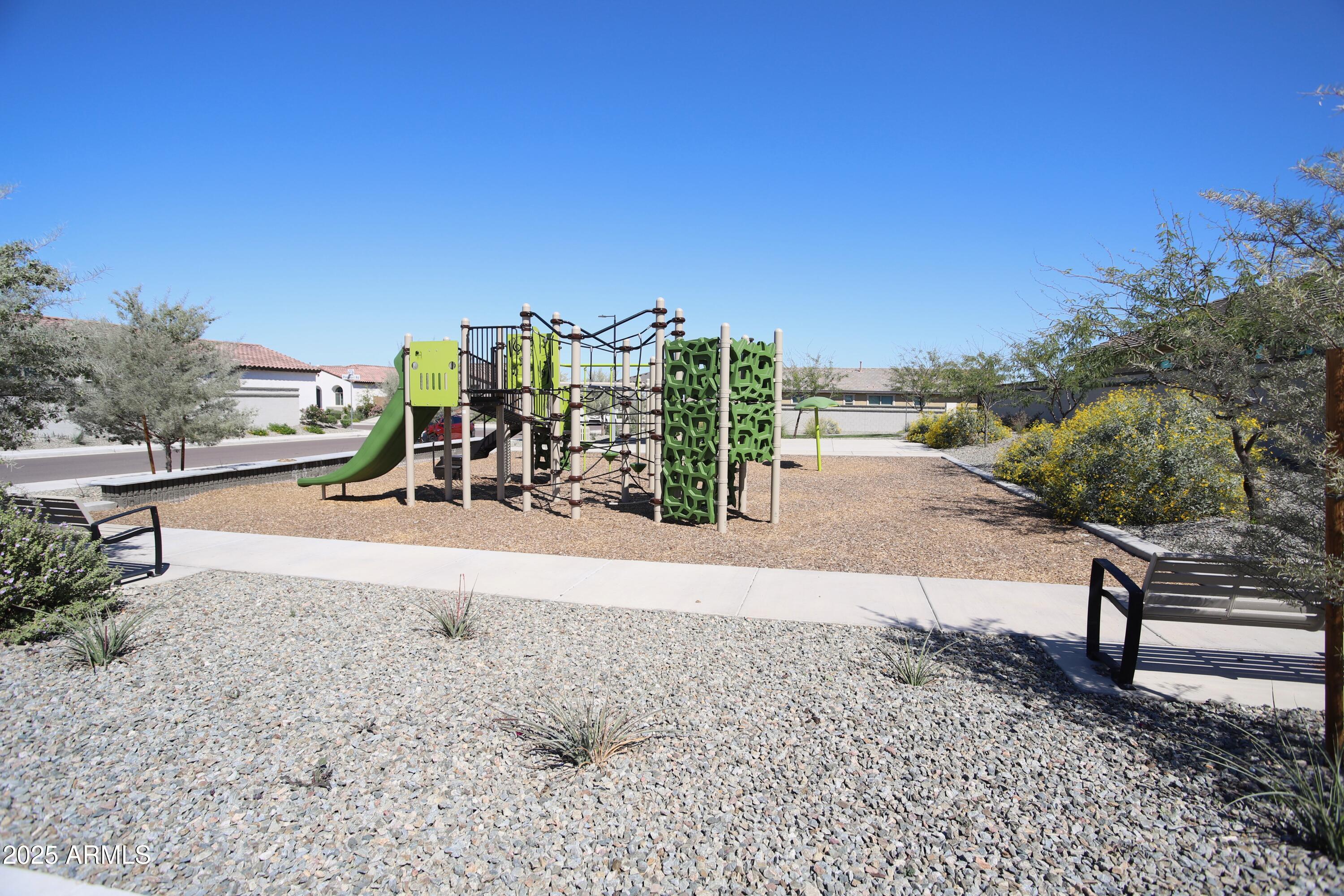 1535 West Corral Road Phoenix, AZ 85041 - Photo 35 of 39 a view of a road with a bench in front of house