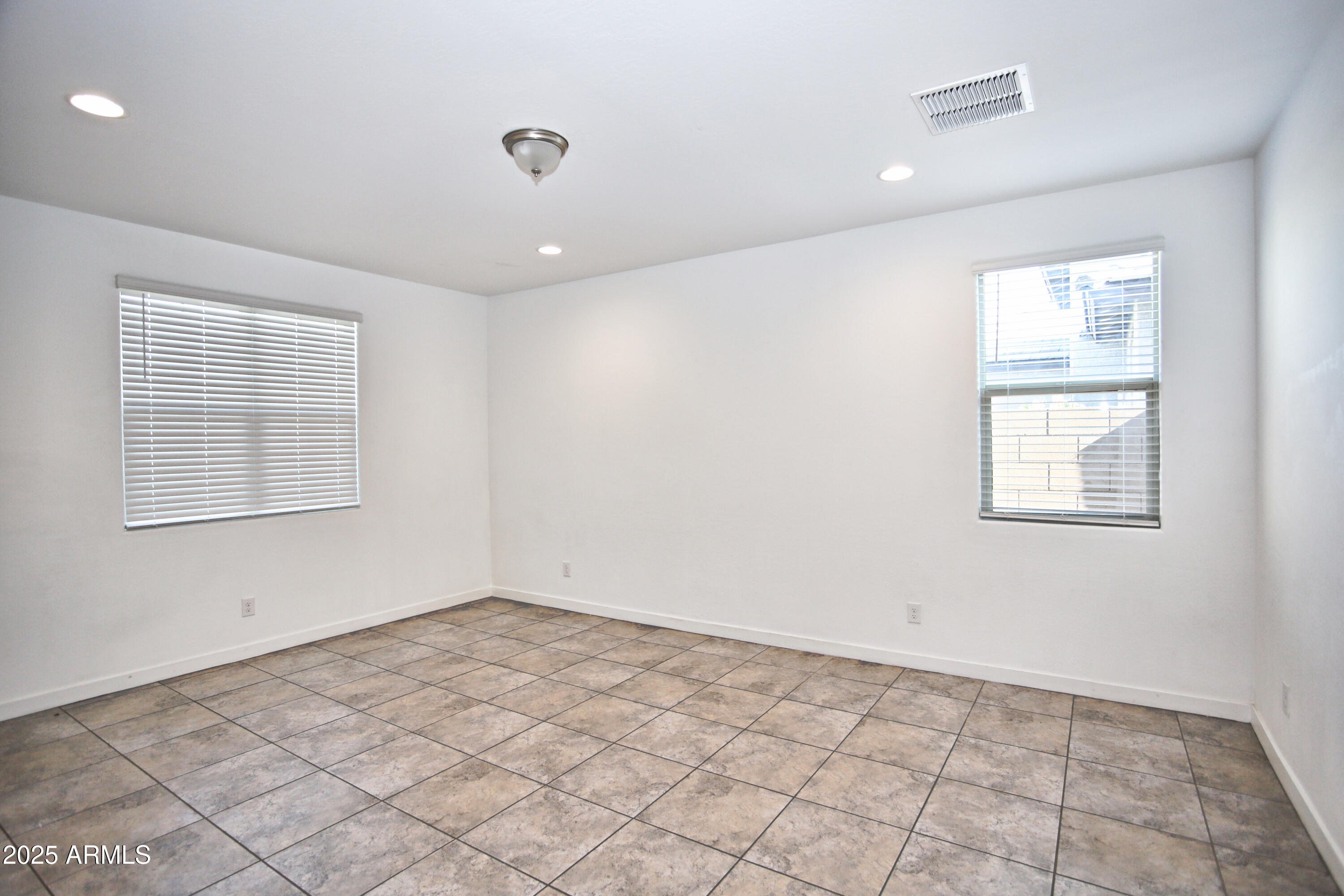 1535 West Corral Road Phoenix, AZ 85041 - Photo 6 of 39 a view of an empty room with a window