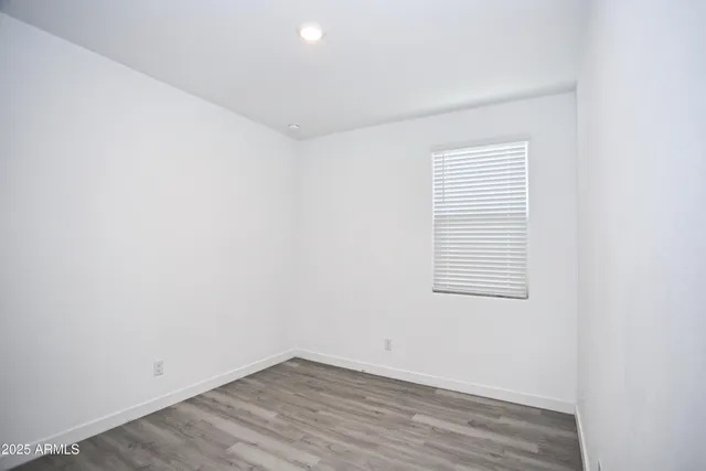 an empty room with wooden floor