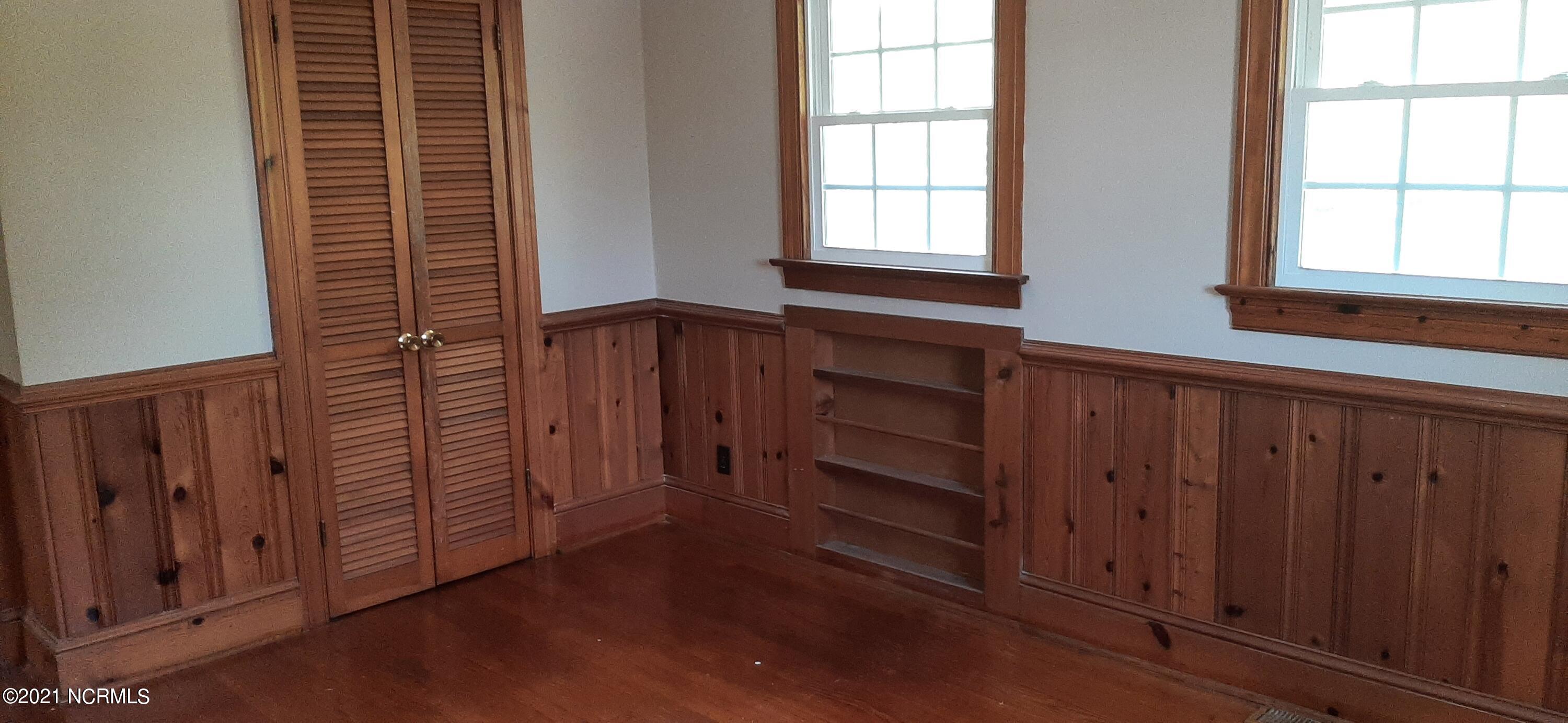 1900 Carey Road Kinston, NC 28501 - Photo 15 of 17 Hardwood floor bedroom with shelves in closet.