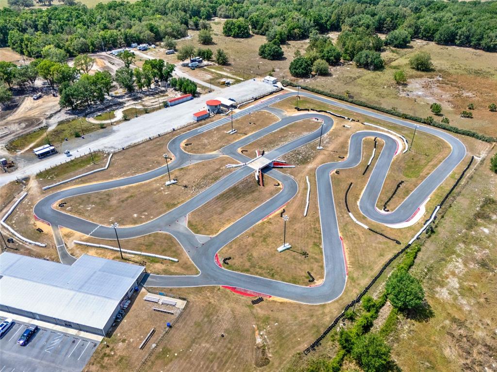 5821 Pit Road Bushnell, FL 33513 - Photo 2 of 35 an aerial view of a swimming pool and outdoor space