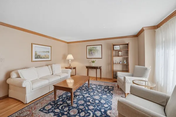 a living room with furniture a lamp and a window