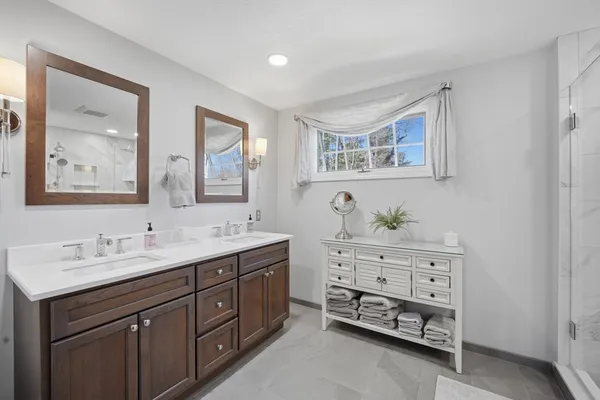a bathroom with a double vanity sink and a mirror