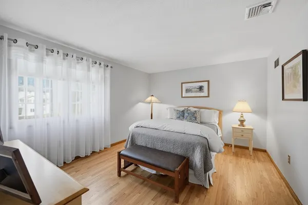 a bed room with a bed and a chair