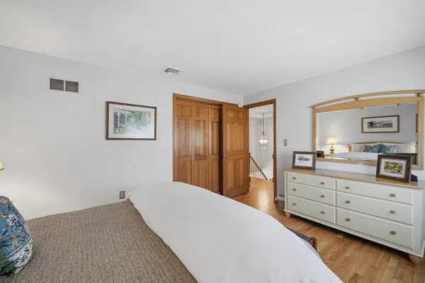 a bedroom with a bed and a dresser in it