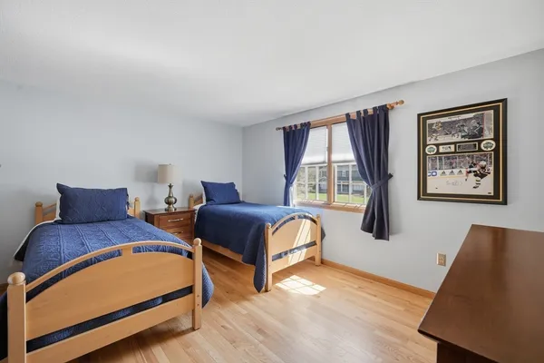 a bedroom with two beds and a large window