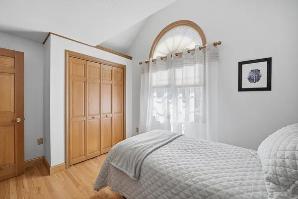 a bedroom with a bed and a mirror