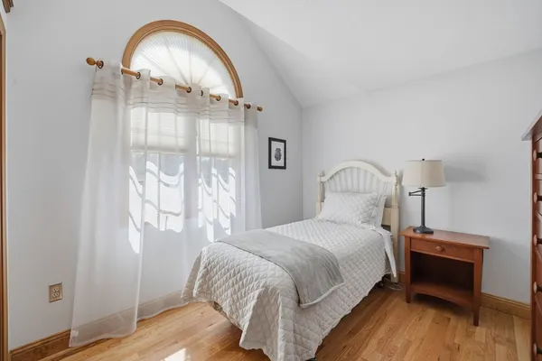 a bedroom with a bed and a mirror
