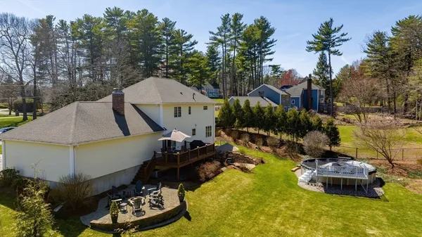 a aerial view of a house with swimming pool and big yard
