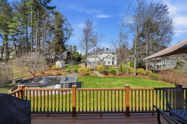 a view of a wooden deck and a yard