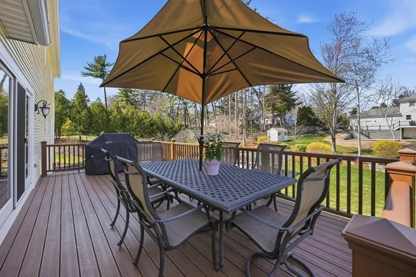 a view of a deck with furniture and umbrella