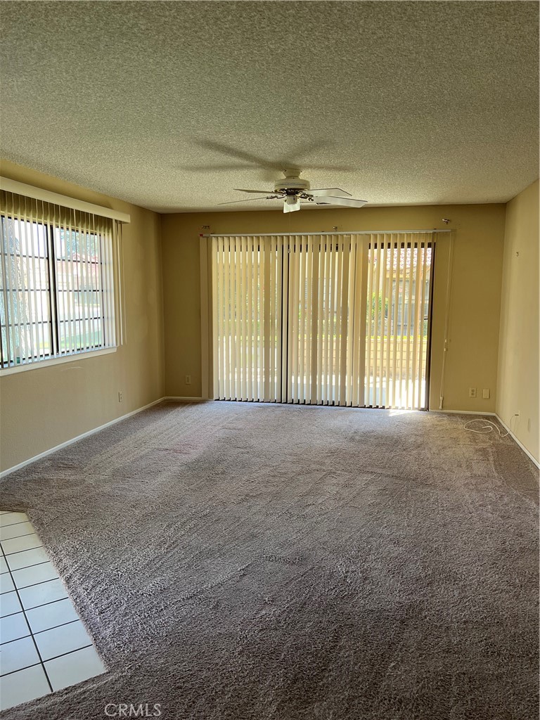 11687 Maple Street Apple Valley, CA 92308 - Photo 4 of 15 a view of an empty room with a window