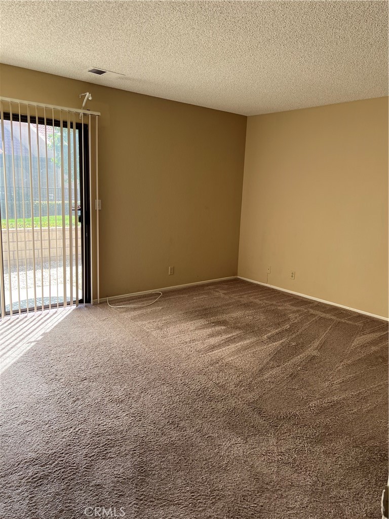 11687 Maple Street Apple Valley, CA 92308 - Photo 6 of 15 a view of an empty room with a window